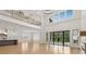 Spacious living room with an open layout, hardwood floors, fireplace and expansive windows at 3735 Hamilton Mill Rd, Buford, GA 30519