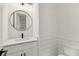 Chic powder room boasts a modern vanity, black fixtures, and wainscoting at 3735 Hamilton Mill Rd, Buford, GA 30519