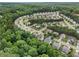 An aerial view of a suburban community surrounded by lush green trees at 5925 Crescent Landing Dr, Cumming, GA 30028