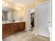 Bathroom featuring dual sinks, vanity, a walk-in closet, and a shower behind glass at 5925 Crescent Landing Dr, Cumming, GA 30028