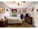 Comfortable bedroom featuring a window with curtains, hardwood floors, and a dresser at 5925 Crescent Landing Dr, Cumming, GA 30028