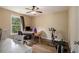 Bright bedroom featuring a desk, exercise equipment, and a window with a wooded view at 5925 Crescent Landing Dr, Cumming, GA 30028