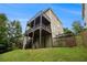Exterior view of a multi-level wood deck overlooking a green yard with ample outdoor entertaining and relaxation at 5925 Crescent Landing Dr, Cumming, GA 30028
