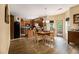 Open-concept kitchen with wood cabinets, island, breakfast area, and outdoor access to the deck at 5925 Crescent Landing Dr, Cumming, GA 30028