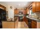 Bright kitchen with wooden cabinets, granite countertops, a center island, and modern appliances at 5925 Crescent Landing Dr, Cumming, GA 30028