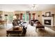 Comfortable living room with fireplace, hardwood floors, and view to outdoor deck at 5925 Crescent Landing Dr, Cumming, GA 30028