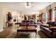 Inviting living room featuring hardwood floors, leather sofas, and a decorative ceiling fan at 5925 Crescent Landing Dr, Cumming, GA 30028