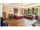 Spacious main bedroom with tray ceiling, large windows, and a comfortable sitting area at 5925 Crescent Landing Dr, Cumming, GA 30028