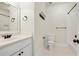 Bright bathroom with white subway tile shower, white vanity, and contrasting dark bronze fixtures at 968 Dean Nw Dr, Atlanta, GA 30318