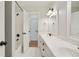 Clean bathroom featuring double sinks, white cabinets, tile floors, and a subway tile shower at 968 Dean Nw Dr, Atlanta, GA 30318