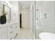 Luxury bathroom with a glass-enclosed shower, subway tiles, double vanity, and stylish fixtures at 968 Dean Nw Dr, Atlanta, GA 30318