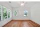 This bedroom offers hardwood floors, three large windows, and neutral paint at 968 Dean Nw Dr, Atlanta, GA 30318