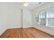 This bedroom provides two large windows with shades, and hardwood flooring at 968 Dean Nw Dr, Atlanta, GA 30318