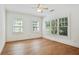 Spacious bedroom featuring hardwood floors, three large windows with backyard views, and a ceiling fan at 968 Dean Nw Dr, Atlanta, GA 30318