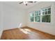 Bright bedroom featuring hardwood floors, large windows with outside views, and a ceiling fan at 968 Dean Nw Dr, Atlanta, GA 30318