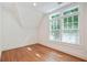 Light-filled bedroom boasts hardwood floors, white trim, and large windows at 968 Dean Nw Dr, Atlanta, GA 30318