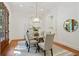Elegant dining room with modern chandelier, glass table, and lots of natural light at 968 Dean Nw Dr, Atlanta, GA 30318