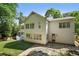 Rear exterior view showing the level yard, multiple windows, and access to outdoor living spaces at 968 Dean Nw Dr, Atlanta, GA 30318