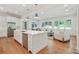 Open-concept kitchen with a large center island, stainless steel appliances, and hardwood floors at 968 Dean Nw Dr, Atlanta, GA 30318