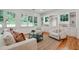 Spacious living room featuring built-in cabinets, a large window, and hardwood floors at 968 Dean Nw Dr, Atlanta, GA 30318