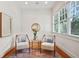 Cozy sitting area with two chairs, neutral colors, and natural light from the window at 968 Dean Nw Dr, Atlanta, GA 30318