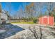 View of the backyard with a shed, a concrete patio, grass, and a fence at 1337 M L King Jr Nw Dr, Atlanta, GA 30314