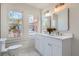 Bright bathroom featuring double vanity, white countertops and a window to the outside at 1337 M L King Jr Nw Dr, Atlanta, GA 30314