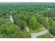 Elevated shot showcasing a home on a wooded lot in a lush neighborhood surrounded by greenery at 3235 Harms Way, Snellville, GA 30039