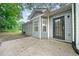 Back of house featuring gray siding, a secure back door, and a small patio at 3235 Harms Way, Snellville, GA 30039