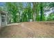 Large backyard with mature trees, offering a serene outdoor space at 3235 Harms Way, Snellville, GA 30039