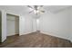 A well-lit bedroom features wood-look floors, a ceiling fan with lighting, and a walk-in closet at 3235 Harms Way, Snellville, GA 30039