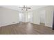Spacious bedroom with wood-look floors, ceiling fan, and convenient access to ensuite bathroom and walk-in closet at 3235 Harms Way, Snellville, GA 30039