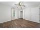 This cozy bedroom offers wood-look floors, a ceiling fan with lighting, and a bright window at 3235 Harms Way, Snellville, GA 30039