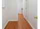 Hallway with wood-look flooring, leading to a laundry room, with easy access to amenities at 3235 Harms Way, Snellville, GA 30039