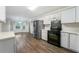 Well-lit kitchen equipped with stainless steel appliances and ample counter space at 3235 Harms Way, Snellville, GA 30039