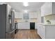 Modern kitchen featuring white cabinets, stainless steel appliances, and durable countertops at 3235 Harms Way, Snellville, GA 30039
