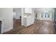 Open concept kitchen featuring white cabinets and stainless appliances plus an adjacent dining area at 3235 Harms Way, Snellville, GA 30039
