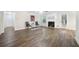 Bright living room with a cozy fireplace, hardwood floors, and a view of the outdoors at 3235 Harms Way, Snellville, GA 30039