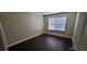 Bedroom with dark wood-look flooring and natural light from a window at 571 Cold Water Ln, Mcdonough, GA 30252