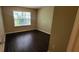 A great bedroom with dark wood-look flooring and natural light streaming in through a window at 571 Cold Water Ln, Mcdonough, GA 30252