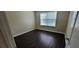 Bedroom featuring dark wood-look floors and a bright window at 571 Cold Water Ln, Mcdonough, GA 30252