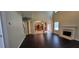 Open-concept living space connects to kitchen and dining area with fireplace and wood floors at 571 Cold Water Ln, Mcdonough, GA 30252