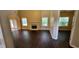 Bright living room boasts high ceilings, fireplace, wood floors, and large windows at 571 Cold Water Ln, Mcdonough, GA 30252