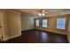 Spacious main bedroom features a ceiling fan, tray ceiling, and large windows with blinds at 571 Cold Water Ln, Mcdonough, GA 30252