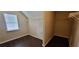 This is a shot of the Walk-in closet with built in shelves and dark wood-look floors at 571 Cold Water Ln, Mcdonough, GA 30252