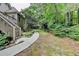 View of a backyard featuring a walkway leading into a wooded area, enhancing the property's natural appeal at 1640 Mount Mckinley Dr, Grayson, GA 30017
