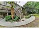 Backyard view showcases lush landscaping, a deck, and a stone walkway, creating a tranquil outdoor space at 1640 Mount Mckinley Dr, Grayson, GA 30017