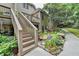 Landscaped backyard with rock garden, stairway to deck and lush green vegetation at 1640 Mount Mckinley Dr, Grayson, GA 30017