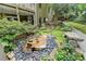 Backyard includes a rock garden, water feature, bench, and landscaping creating a relaxing outdoor space at 1640 Mount Mckinley Dr, Grayson, GA 30017