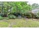 Backyard featuring a lush lawn, mature trees, and comfortable seating at 1640 Mount Mckinley Dr, Grayson, GA 30017
